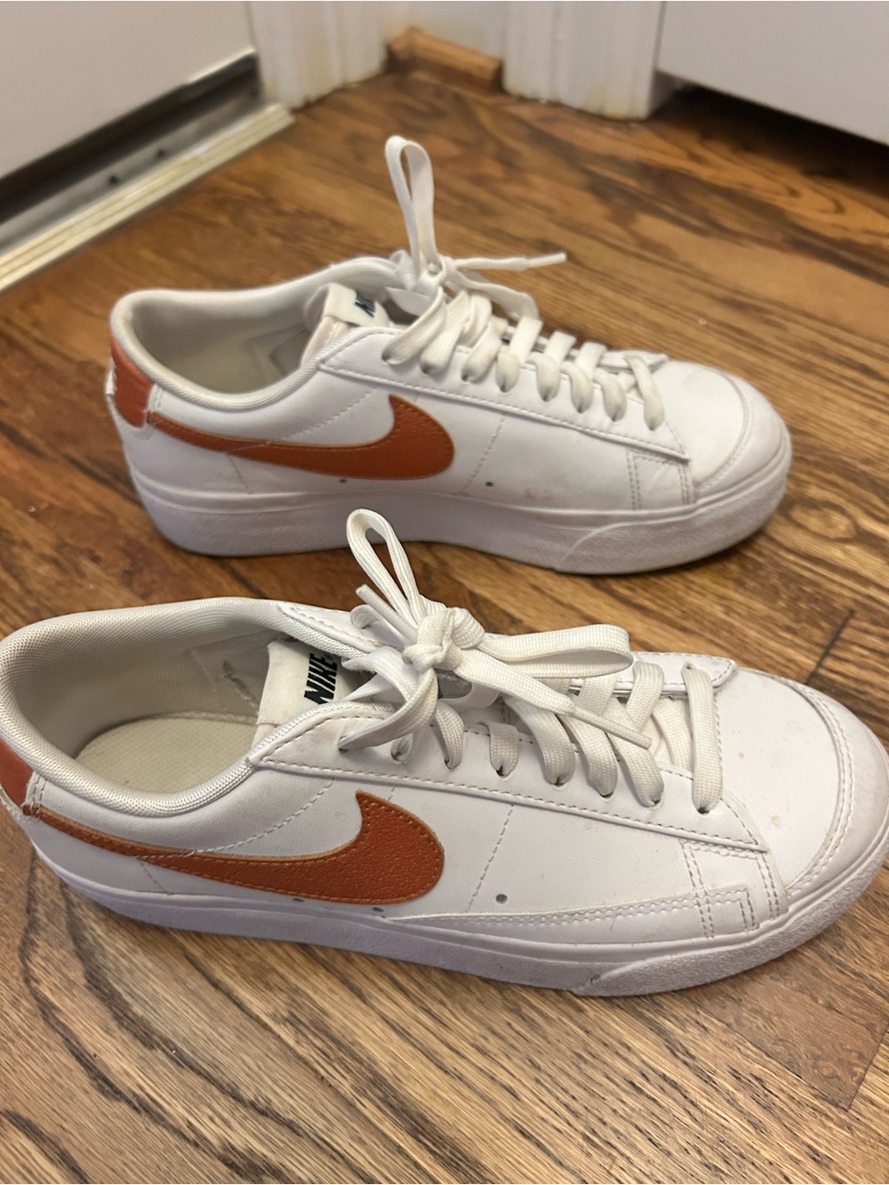Nike White Low-Top Sneakers with Orange Swoosh